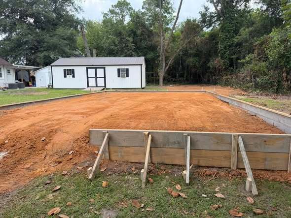View of the new storeroom construction, preparing the foundation for household furniture donations