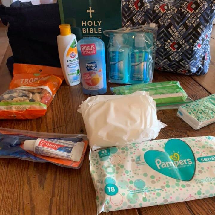 Community members receiving care packages and supplies